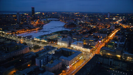 Obraz premium Skyscrapers with illumination in city at night, top view from One building. Night city with skyscrapers top view. Timelapse