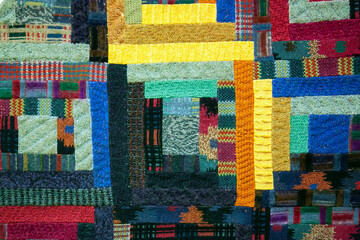 Colorful knitted wool textured patchwork close up