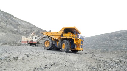 Heavy mining trucks moving on a limestone quarry. Heavy equipment.