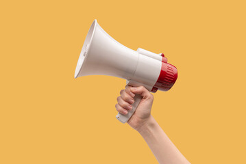 Megaphone in woman hands on a white background.