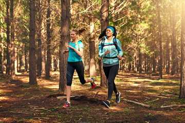 Fototapeta premium Our favorite place to exercise is in nature. Shot of two sporty young women out exercising in nature.