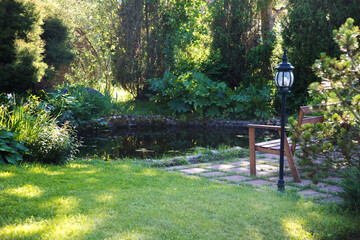 A place for a secluded rest by the pond with a bench.