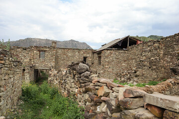 ruined stone houses on the street in abandoned mountain village Old Koroda in Dagestan, Russia