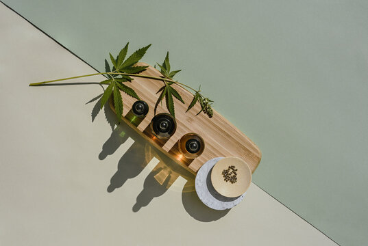 Different from bottle on a wooden podium with cannabis seeds leaves om marjuana