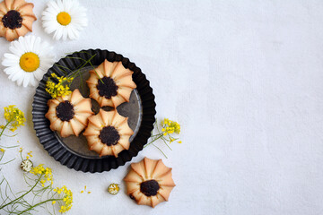 Layout of cookies and flowers on a light background. copy space