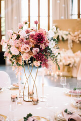 Flower table decorations for holidays and wedding dinner. Table set for holiday, event, party or wedding reception in a restaurant.