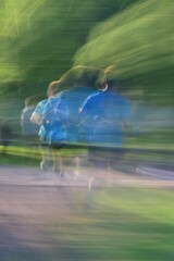 Young male running in a park with motion blur