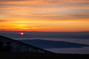 View of Umbria valley Italy above a sea of fog at sunset