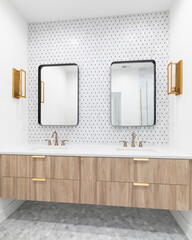 A beautiful bathroom with a floating wood vanity cabinet, gold faucet and lights, mosaic tile wall, and rectangular mirrors.