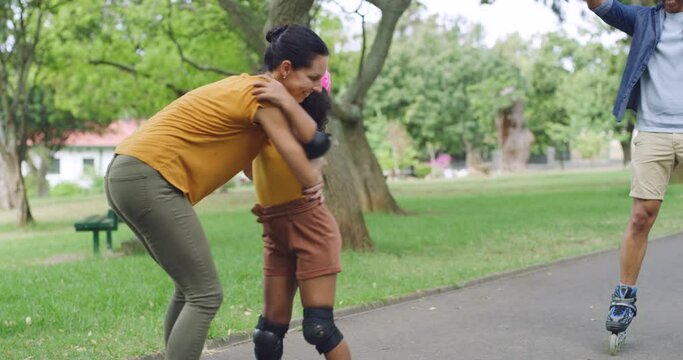 Adorable girl learning to rollerskate with parents cheering, encouraging and supporting her. Cute little latino learning how to skate in park with mother and father. Man and woman teaching daughter