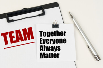 On the tablet, a sheet of paper and stickers with the inscription - TEAM, Together Everyone Always...