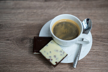 cup of coffee espresso and chocolate on wooden table