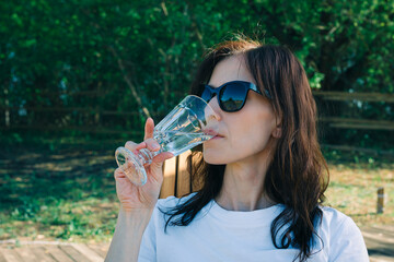 Woman enjoy party drink of cup of white wine in camping, outdoor party vacation