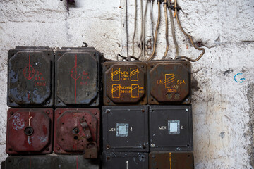 Old electric board in an abandoned building. Photo taken in natural, low light conditions