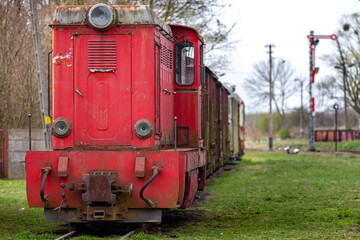 Fototapeta na wymiar An old, narrow track diesel locomotive standing at the museum's train station. Picture taken on a cloudy day, soft natural light.