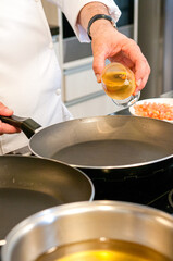 Shrimps being seasoned by the Chef and fried in the frying pan.
