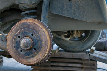 car without a wheel, close-up of a rusty brake disc