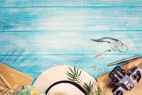 Top view of summer beach accessories on marine blue planks pier. Background with copy space and visible wood texture.