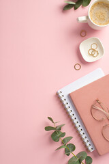 Fototapeta na wymiar Business concept. Top view vertical photo of workspace pink planners gold rings stylish glasses cup of coffee and eucalyptus on isolated pink background