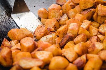 Potatoes are cooked in a street pan