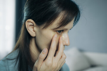 Woman applying under eye patch at home doing a skincare beauty routine product application