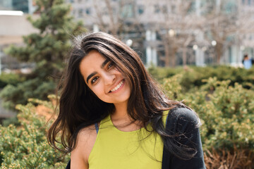 Portrait of happy young girl with long hair smiling