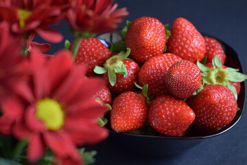 A ration of fresh strawberries on a black background
