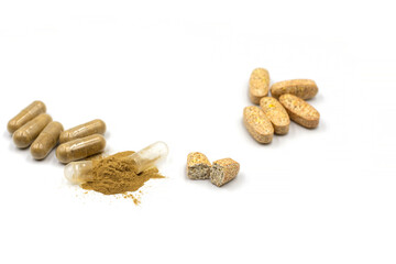 Comparison of vitamins in capsules with tablets. Open capsule and broken tablet. White background