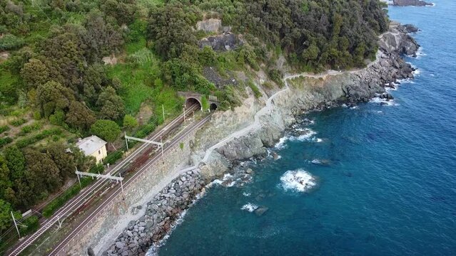 Europe, Italy , Framura , Liguria, 5 Terre - the new promenade  by the sea (via del mare) - drone aerial view of seacoast with railway train binary - from Levanto to Framura with bike on board sea