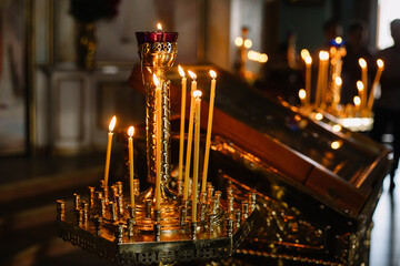 Many candles burn in the Orthodox Church. Element of the russian, ukrainian rite: wedding, funeral,...