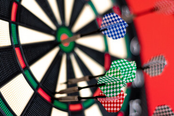 close-up of darts stuck in a dartboard. selective focus