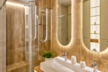 Interior of bathroom with ceramic washbasin with faucet, wooden tiles on the wall and modern...