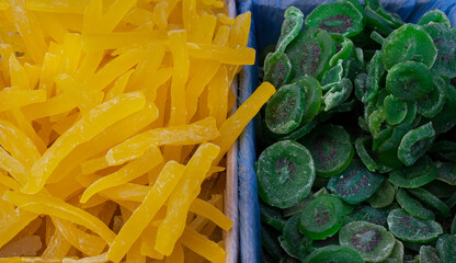 Dried fruits  melon,  kiwi, а pile of candied slices in boxes at the market..