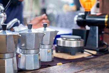 Aluminium moka pot on old wooden table, street food, vintage