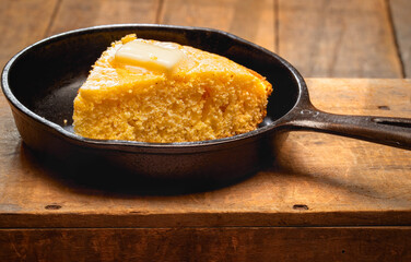 Iron skillet with cornbread and melting butter