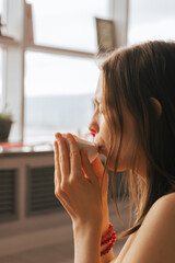 Woman sit on the floor and drink tea from herbs and flowers. Tea ceremony during relaxation harmony