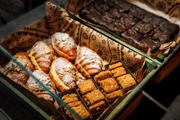 Various fresh bakery , pastry on display window, pie, chocolate and vanilla croissant