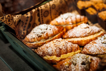 Various fresh bakery , pastry on display window, pie, chocolate and vanilla croissant