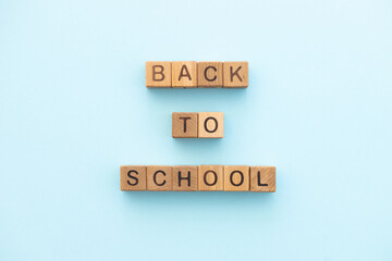 Back to school written of wooden cubes on blue background