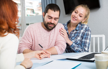 Obraz premium Portrait of mature woman and daughter with her husband holding documents at table
