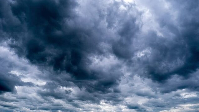 Timelapse of dramatic storm clouds moving in the sky. Dark cumulus clouds change their shape in cloud space. Scenic sky. Dramatic atmosphere background, time lapse. Change of weather. Nature. 4K