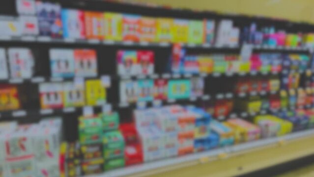 Abstract blurred colorful Pan Beer section in a retail grocery store faded film