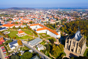 Fototapeta na wymiar Panoramic view from drone of Czech town of Kutna Hora overlooking medieval Jesuit College and St. Barbara Cathedral on sunny autumn day, Central Bohemian Region..