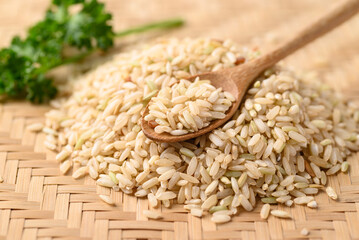 Thai brown rice grain with spoon, Organic rice, Healthy food ingredients