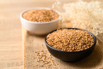 Golden flax seed or linseed in bowl, Healthy food ingredients