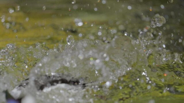This slow motion video shows a wild Bufflehead (Bucephala albeola) duck attacking another duck with water splashing everywhere.