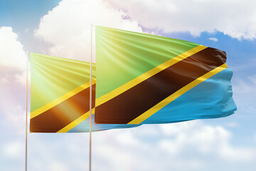 Sunny blue sky and flags of tanzania and tanzania
