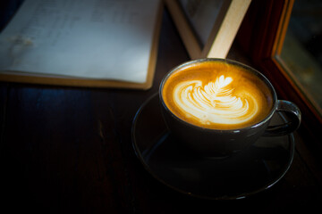hot latte art coffee on wood table, relax time
