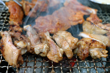 Chicken ribs are grilled over the fire with smoke.