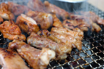 Chicken ribs are grilled over the fire with smoke.